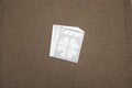 A single white bone sorting sheet with printed text and illustrations placed on a brown surface.