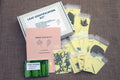 An educational leaf identification kit displayed, including a guide, activities, real tree leaves in plastic sleeves, and a tree finder booklet.